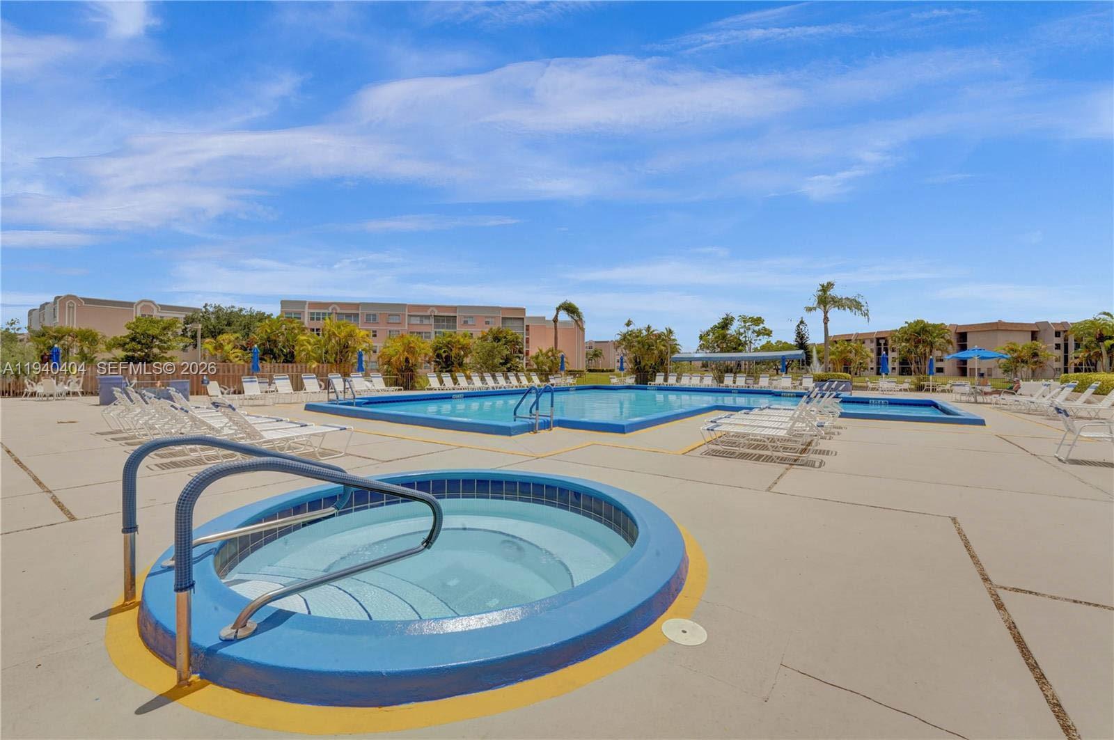 2541 North Nob Hill Road, Unit 309 Sunrise, FL 33322 - Photo 21 of 31 a view of swimming pool with outdoor seating and shower in the back