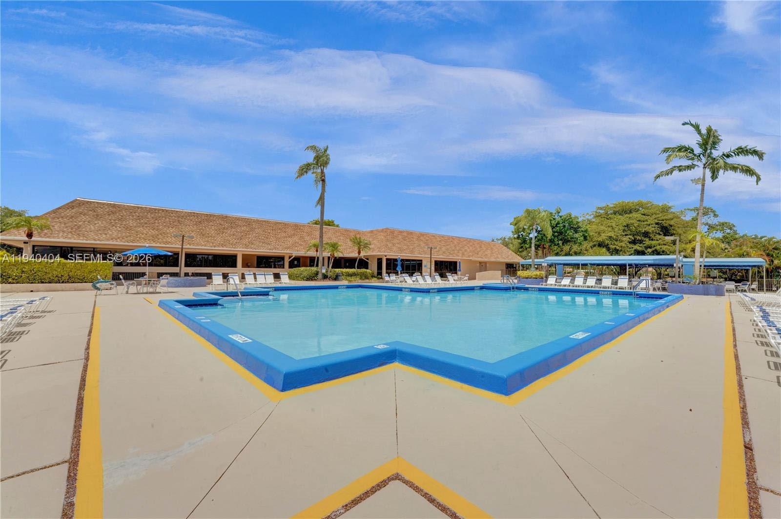2541 North Nob Hill Road, Unit 309 Sunrise, FL 33322 - Photo 22 of 31 a view of swimming pool with a yard