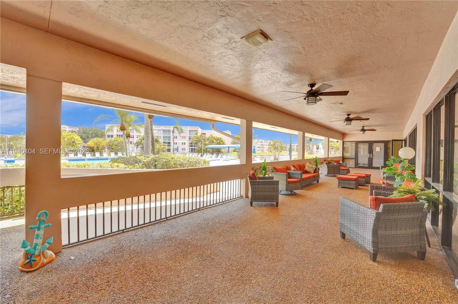 2541 North Nob Hill Road, Unit 309 Sunrise, FL 33322 - Photo 23 of 31 a view of a livingroom with furniture and floor to ceiling window