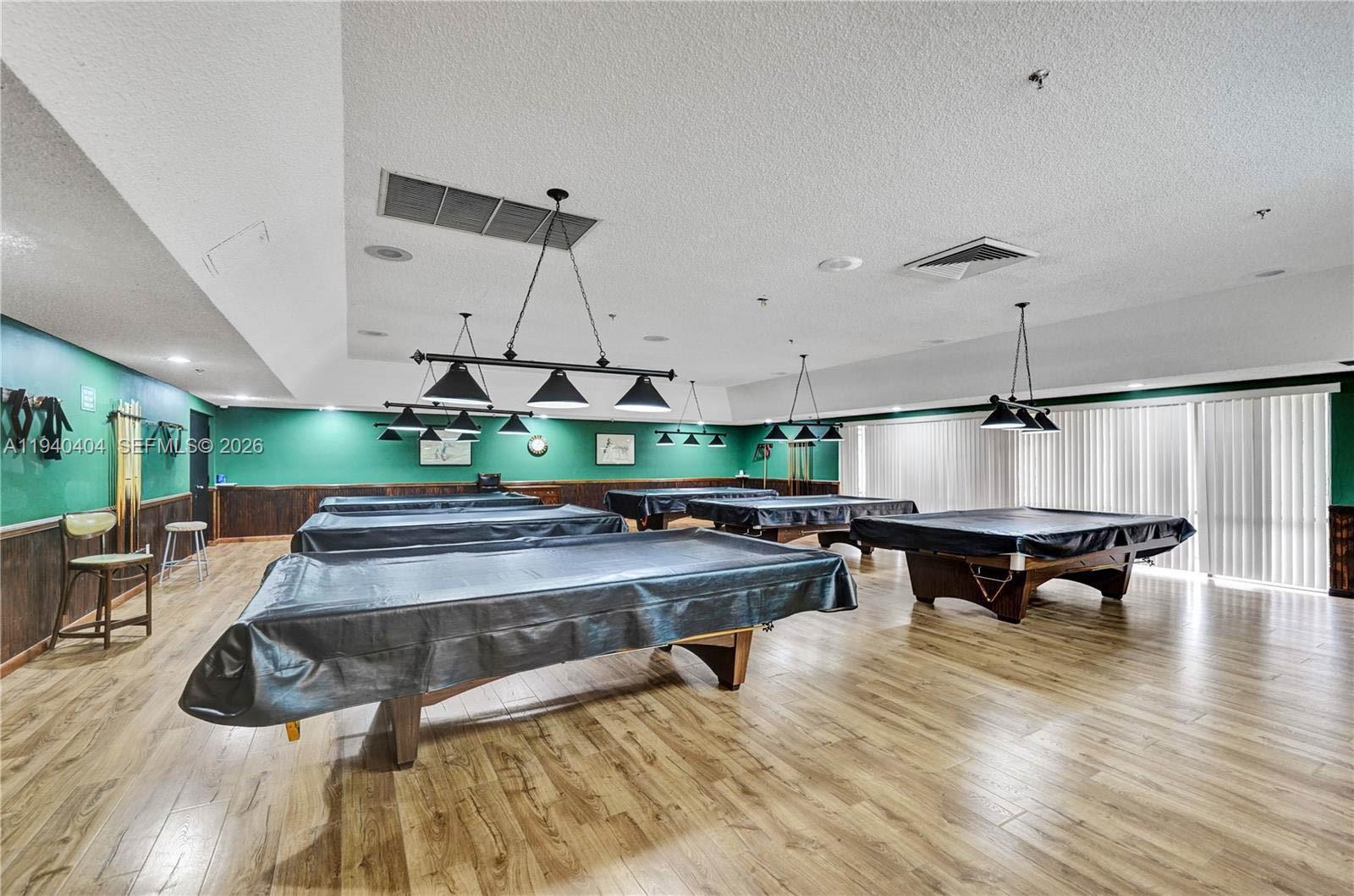 2541 North Nob Hill Road, Unit 309 Sunrise, FL 33322 - Photo 27 of 31 a living room with chairs and wooden floor