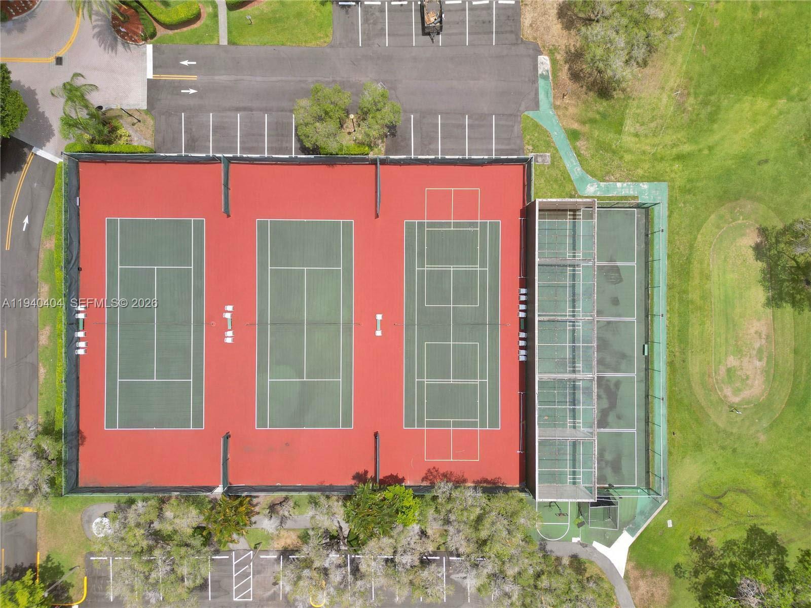 2541 North Nob Hill Road, Unit 309 Sunrise, FL 33322 - Photo 30 of 31 a front view of a house with a yard and potted plants