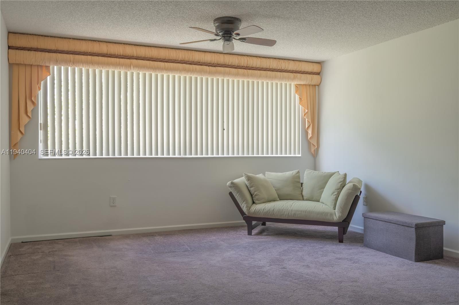 2541 North Nob Hill Road, Unit 309 Sunrise, FL 33322 - Photo 31 of 31 a living room with furniture and a window
