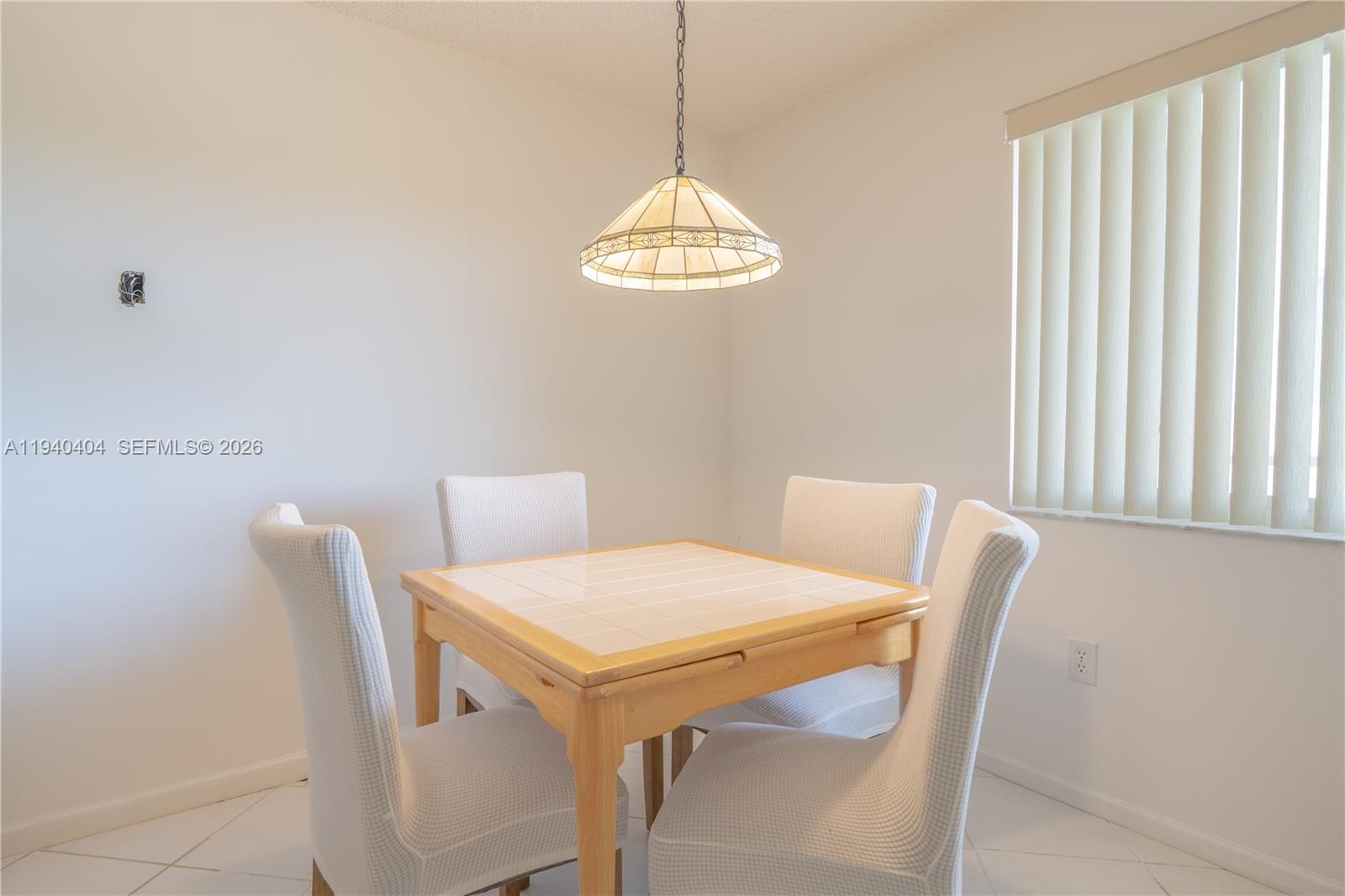 2541 North Nob Hill Road, Unit 309 Sunrise, FL 33322 - Photo 4 of 31 a dining room with a table and chairs