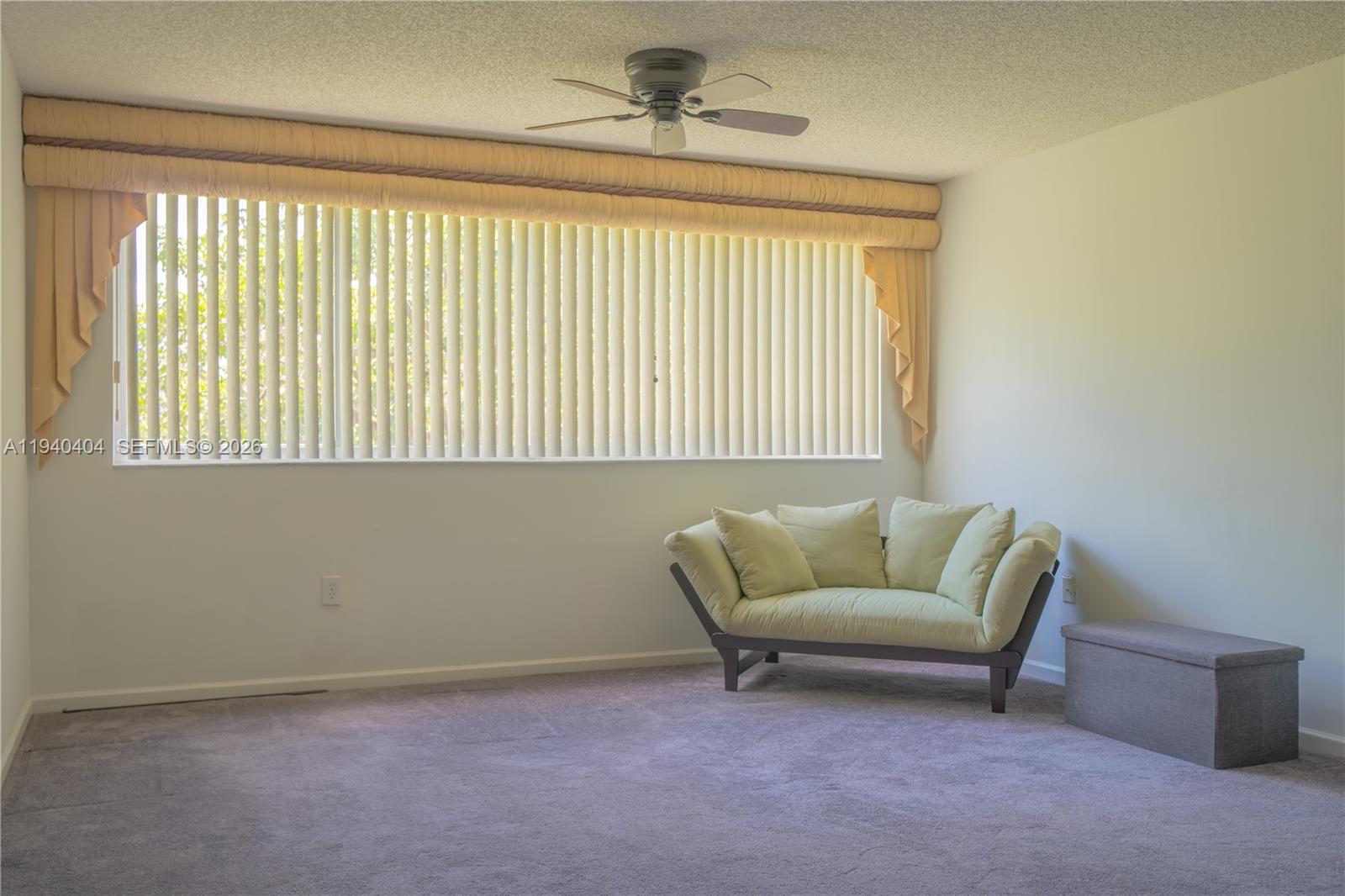 2541 North Nob Hill Road, Unit 309 Sunrise, FL 33322 - Photo 5 of 31 a living room with furniture and a window