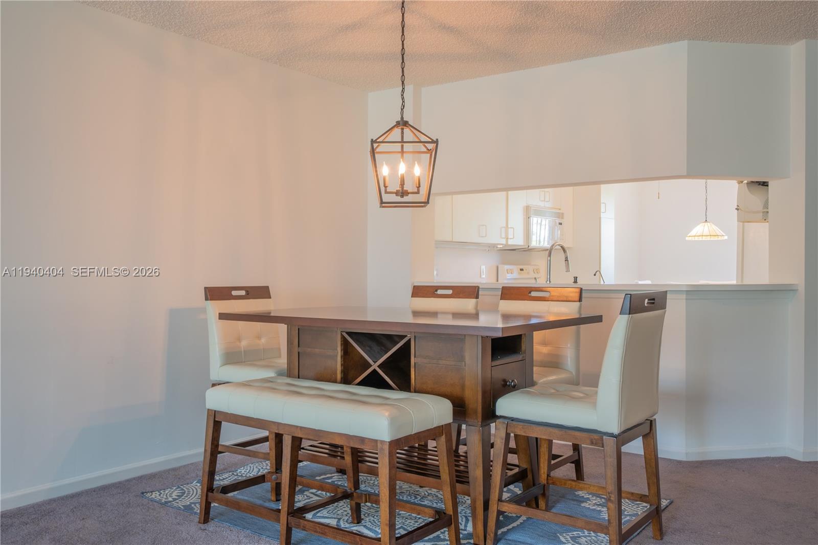 2541 North Nob Hill Road, Unit 309 Sunrise, FL 33322 - Photo 6 of 31 a view of a kitchen with a dining table and chairs