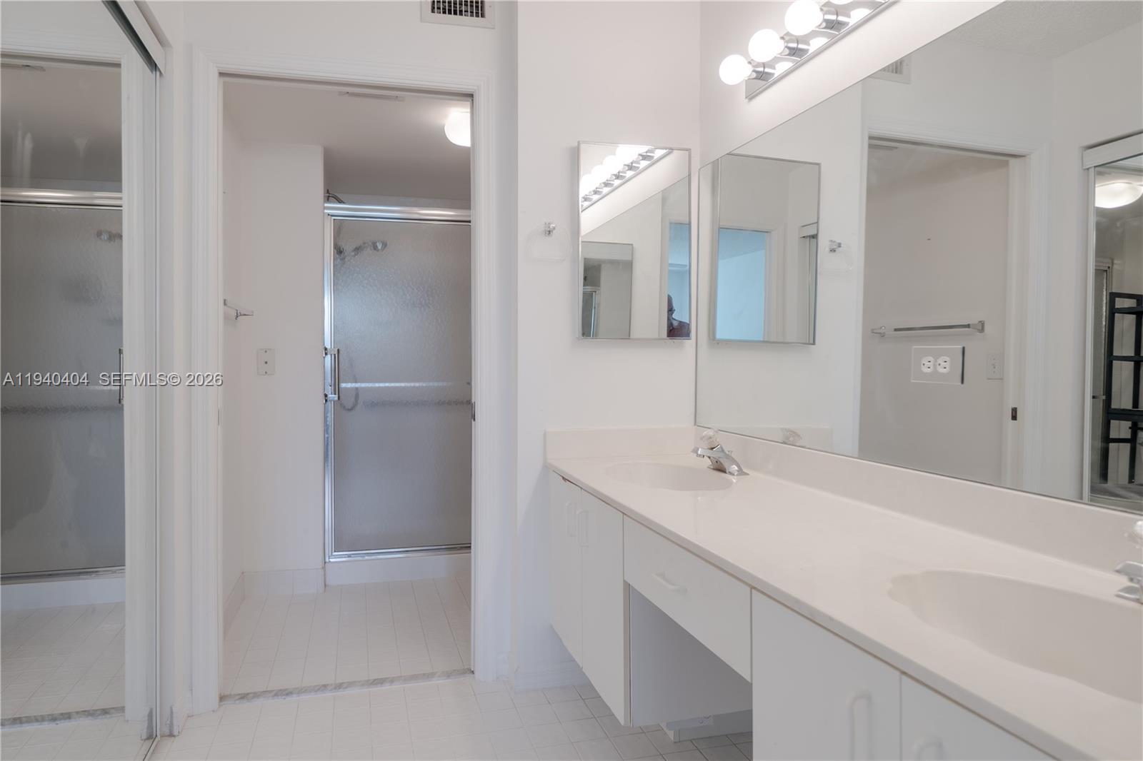 2541 North Nob Hill Road, Unit 309 Sunrise, FL 33322 - Photo 9 of 31 a bathroom with a sink and a mirror
