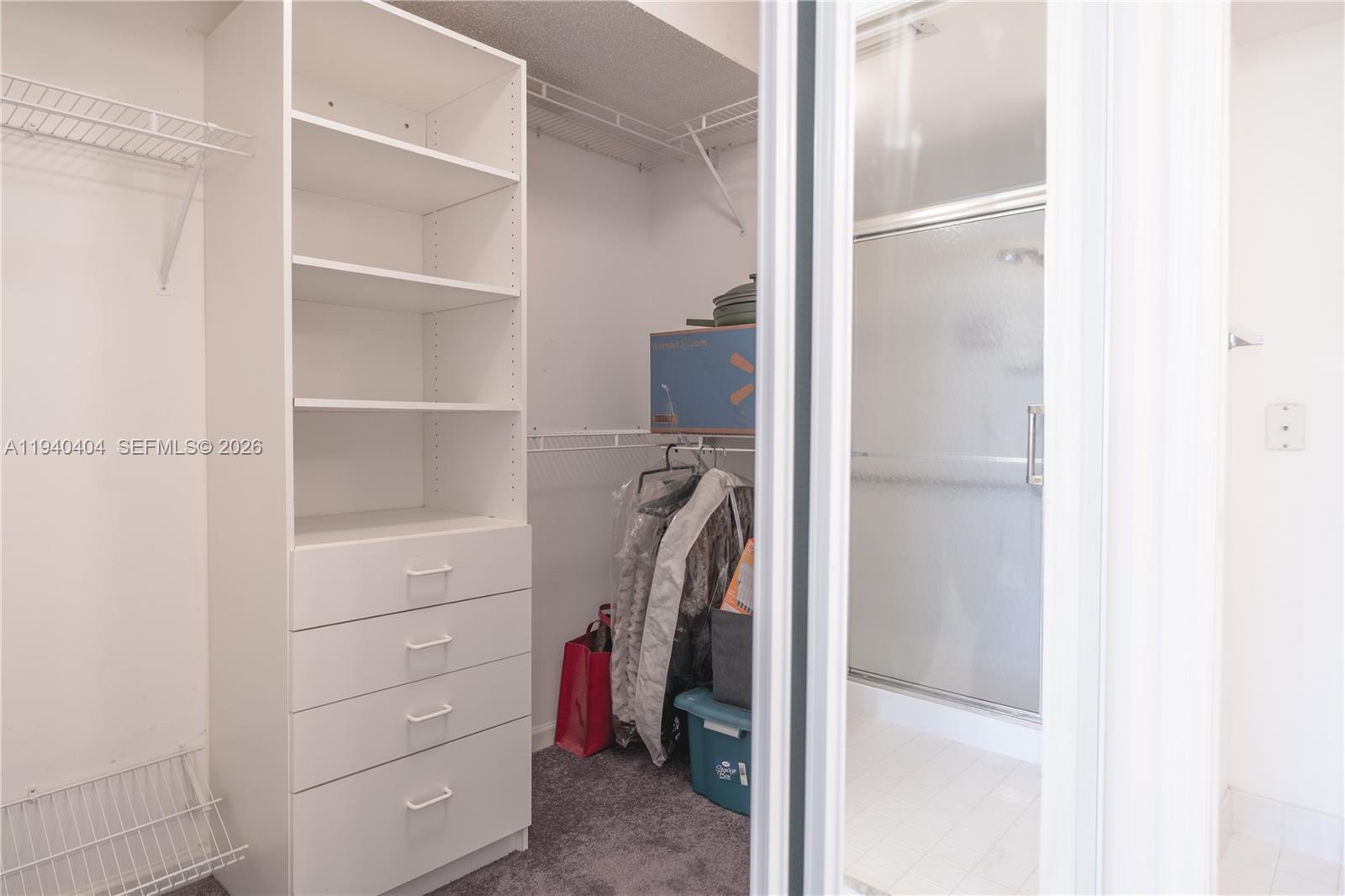 2541 North Nob Hill Road, Unit 309 Sunrise, FL 33322 - Photo 10 of 31 a view of walk in closet with empty racks