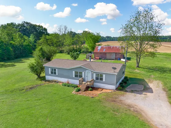 an aerial view of a house with swimming pool garden and outdoor seating