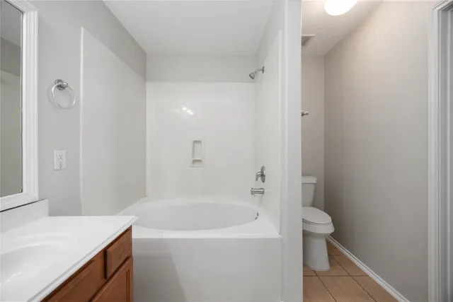 a white bath tub sitting next to a white toilet