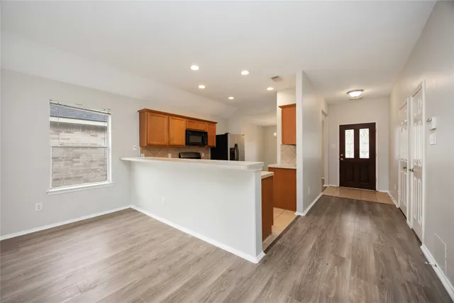 a view of a kitchen cabinets and wooden floor