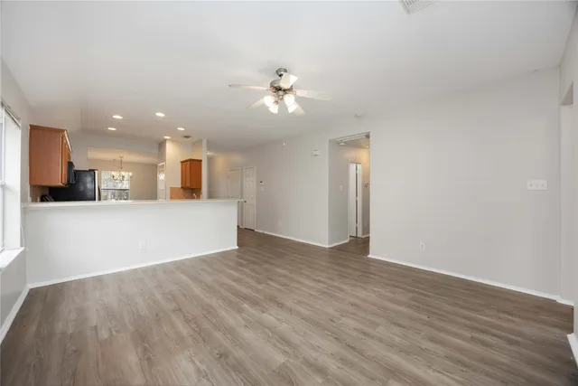 a view of a kitchen with wooden floor and a kitchen