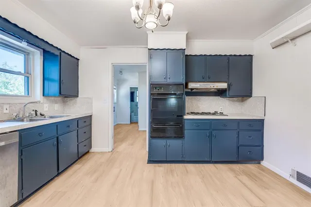 a kitchen with stainless steel appliances granite countertop a sink refrigerator and microwave