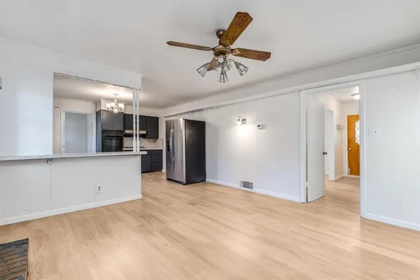 a view of a kitchen with a sink and stainless steel appliances