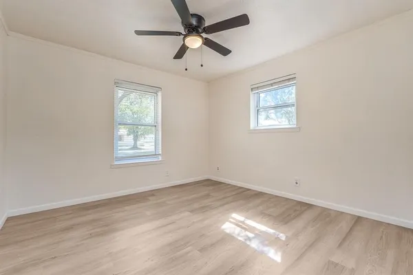 a view of empty room with ceiling fan