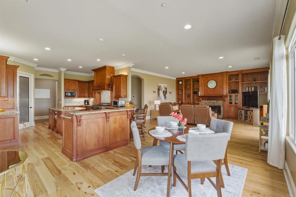 4712 Briana Court Fallbrook, CA 92028 - Photo 11 of 40 a dining room with stainless steel appliances kitchen island granite countertop a dining table chairs and a living room view