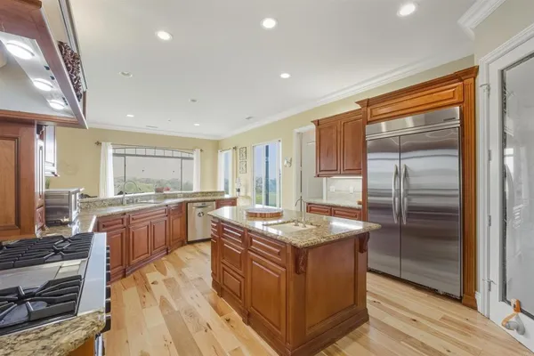 a kitchen with a stove a sink and a refrigerator