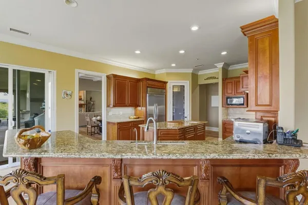 a kitchen with granite countertop sink and cabinets