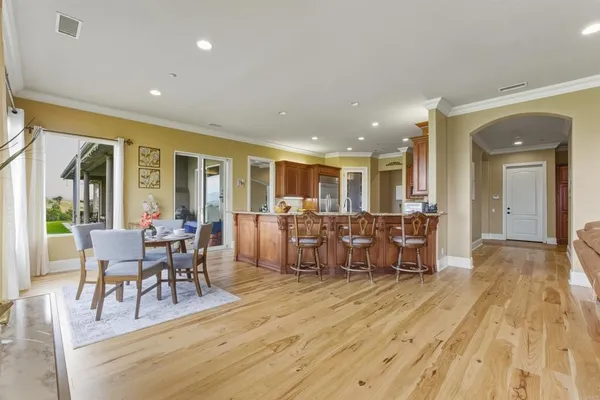 a living room with furniture a wooden floor and a large window