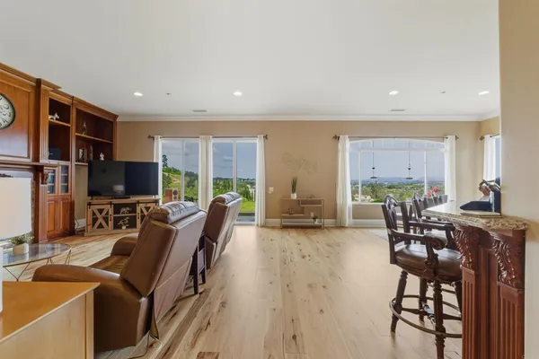 a living room with furniture a flat screen tv and a large window