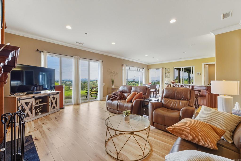 4712 Briana Court Fallbrook, CA 92028 - Photo 19 of 40 a living room with furniture kitchen view and large windows