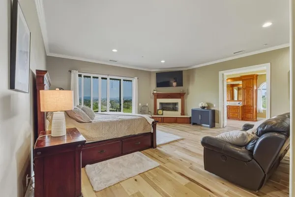 a living room with furniture a fireplace and a large window