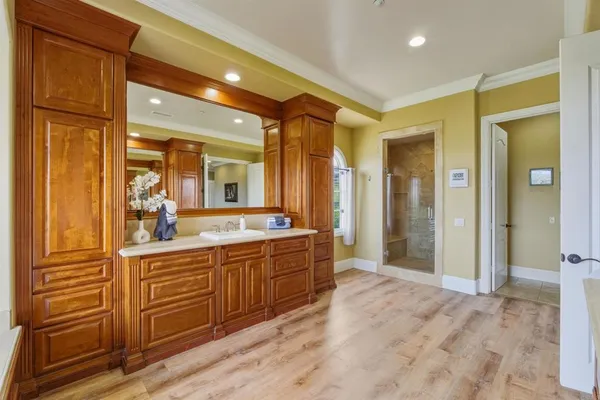 a large bathroom with a glass door shower and sink
