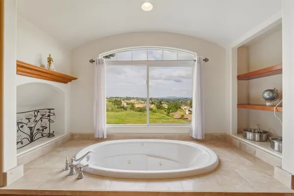 a bathroom with a tub and a window