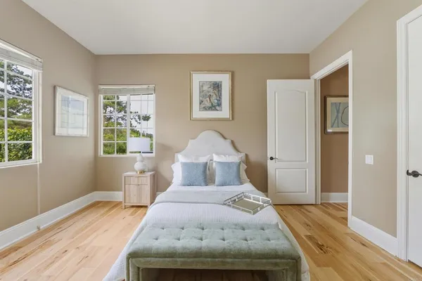 a bedroom with a bed and wooden floor