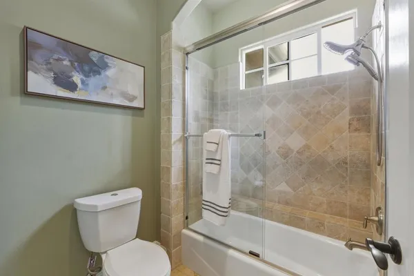 a bathroom with a toilet and a shower