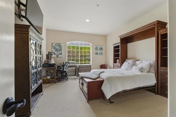 a bedroom with bed couch and window