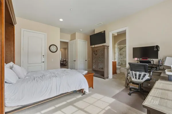 a bedroom with a bed and flat screen tv