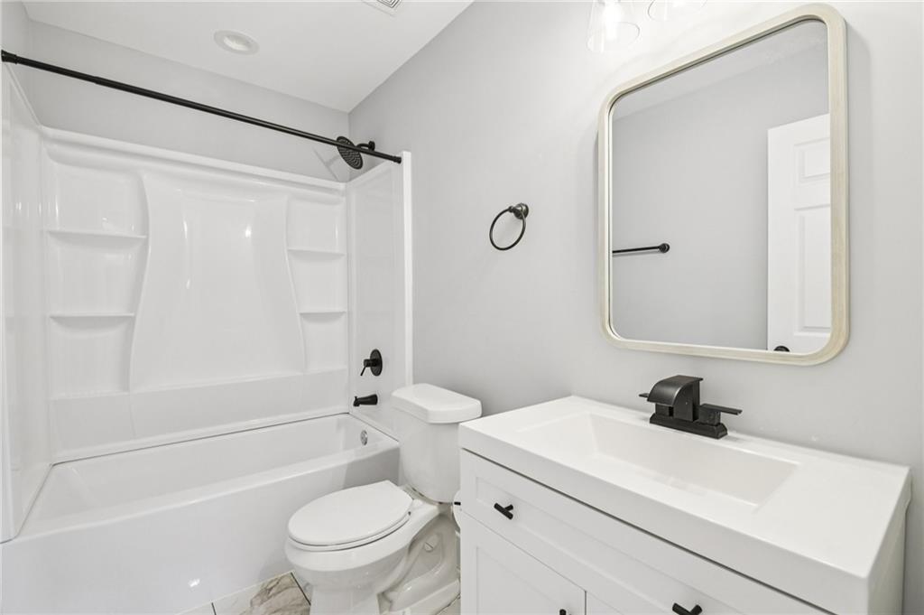 985 Timber Trail Austell, GA 30168 - Photo 12 of 15 a bathroom with a sink a toilet and a mirror