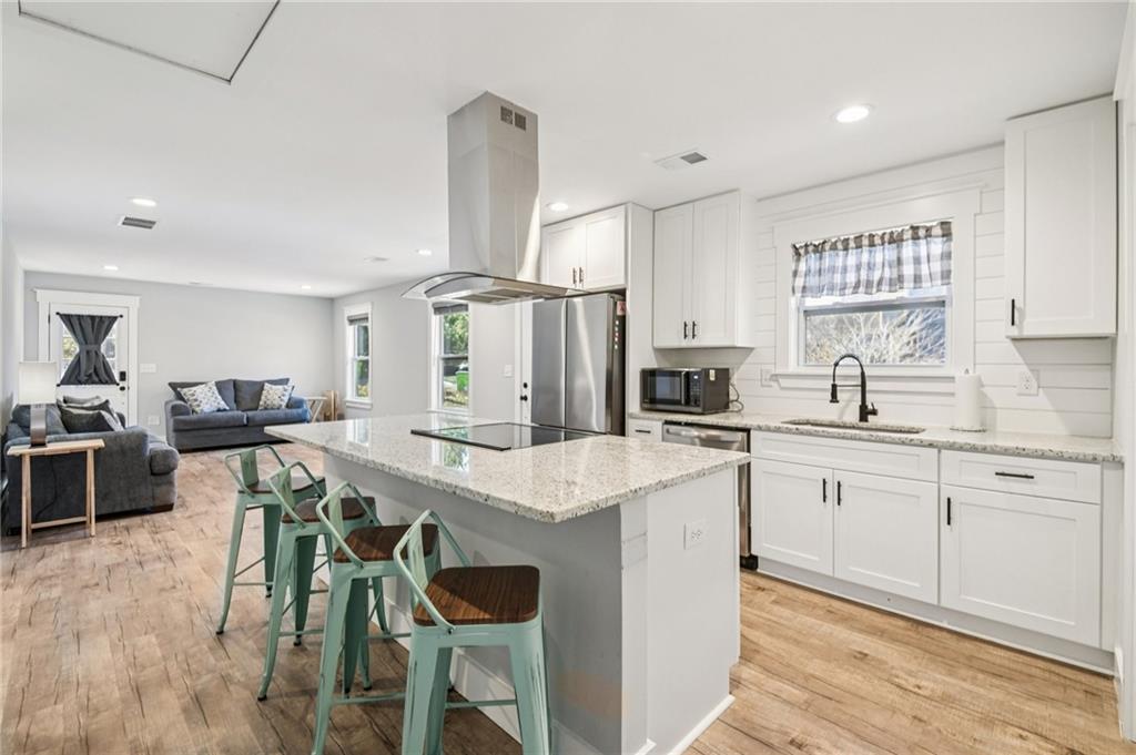 985 Timber Trail Austell, GA 30168 - Photo 4 of 15 a kitchen with a table chairs sink and cabinets