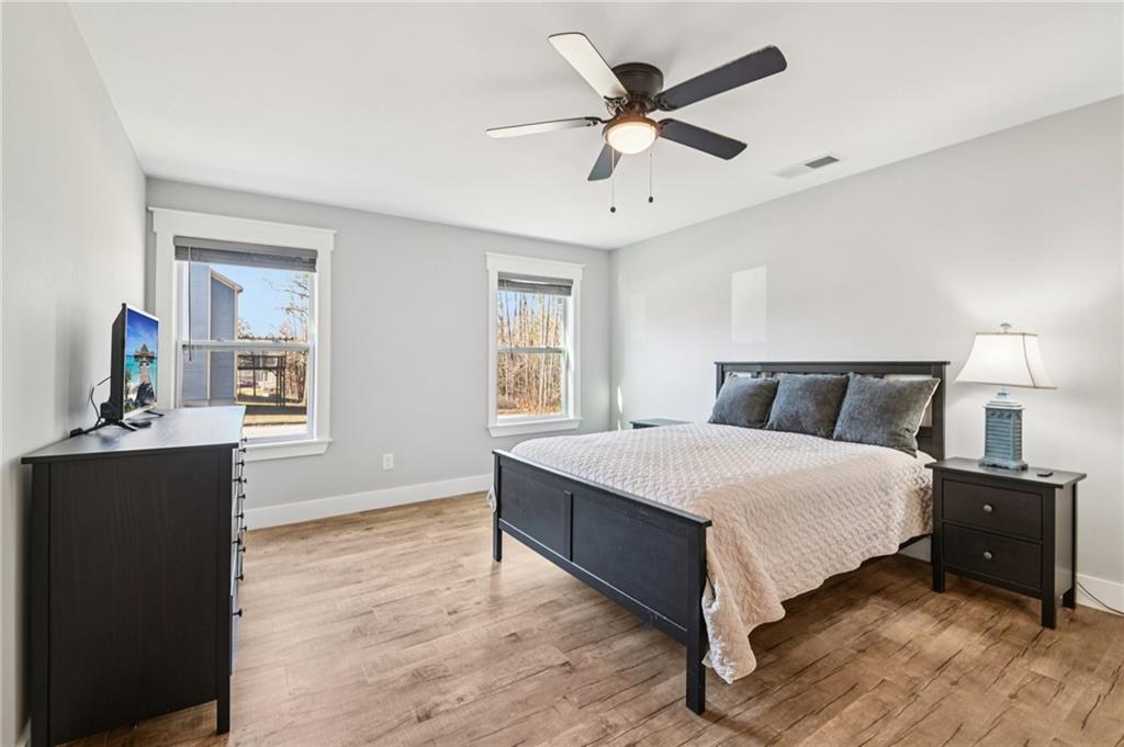 985 Timber Trail Austell, GA 30168 - Photo 7 of 15 a bedroom with a bed and wooden floor