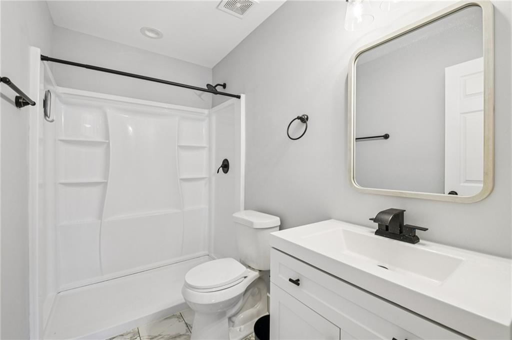 985 Timber Trail Austell, GA 30168 - Photo 9 of 15 a bathroom with a sink a toilet and shower