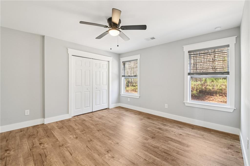 985 Timber Trail Austell, GA 30168 - Photo 10 of 15 an empty room with wooden floor fan and windows