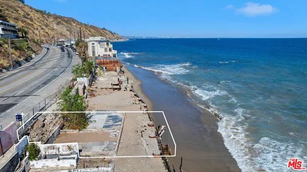 a view of a ocean with a building in the background