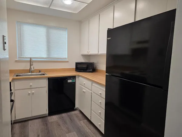 a kitchen with a sink and a refrigerator