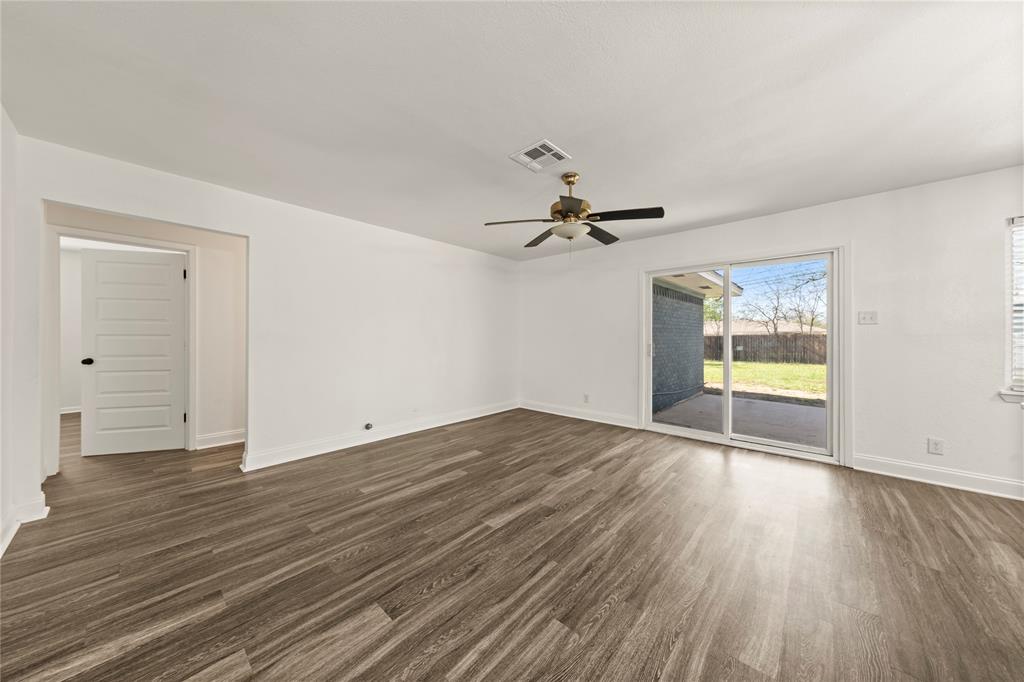104 East Santa Anna Street Robinson, TX 76706 - Photo 11 of 36 a view of empty room with wooden floor and fan