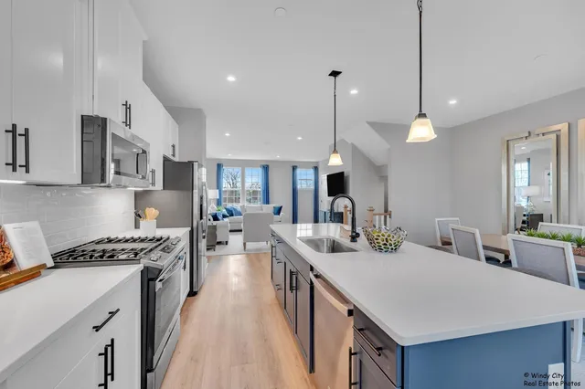 a kitchen with counter top space a sink stainless steel appliances and cabinets