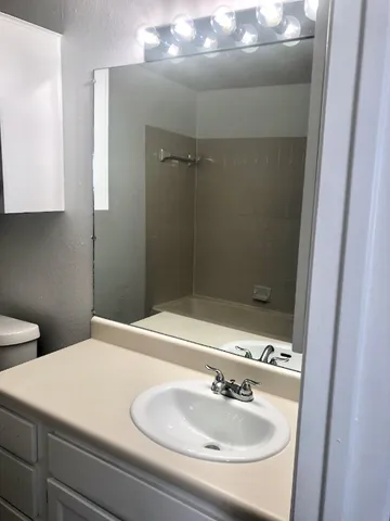 a bathroom with a sink and a mirror