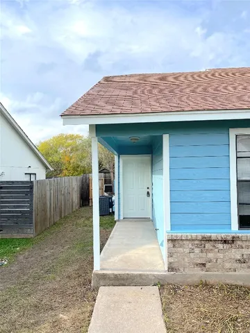 a view of a house with wooden fence