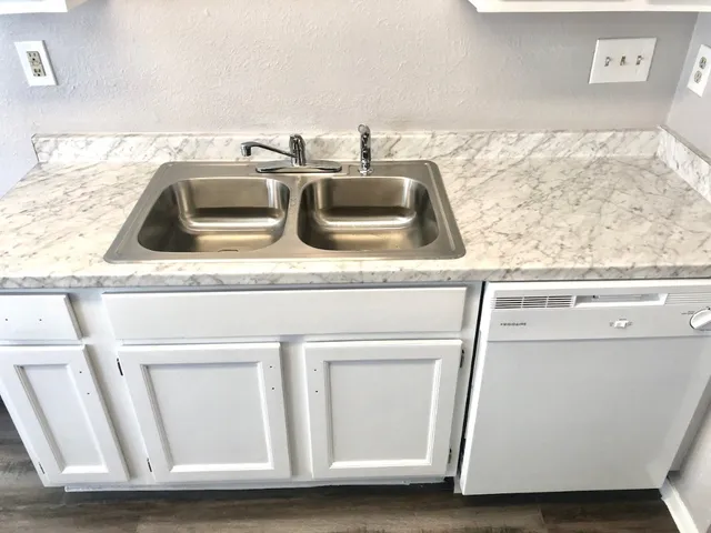 a kitchen with a sink and a stove top oven