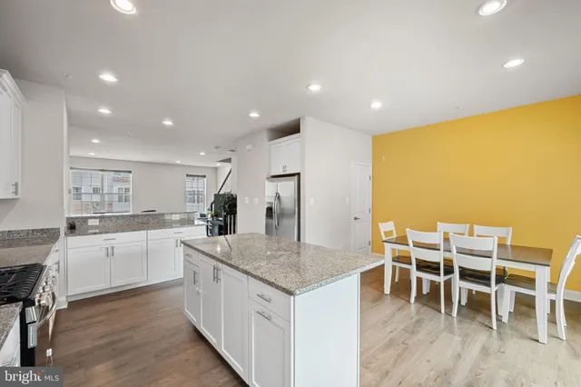 a kitchen with a sink and chairs