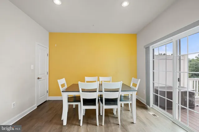 a dining room with furniture and wooden floor