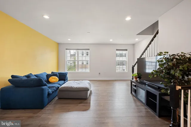 a living room with furniture and a potted plant