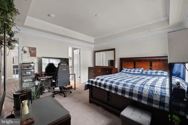 a bedroom with a bed gym equipment and view of living room