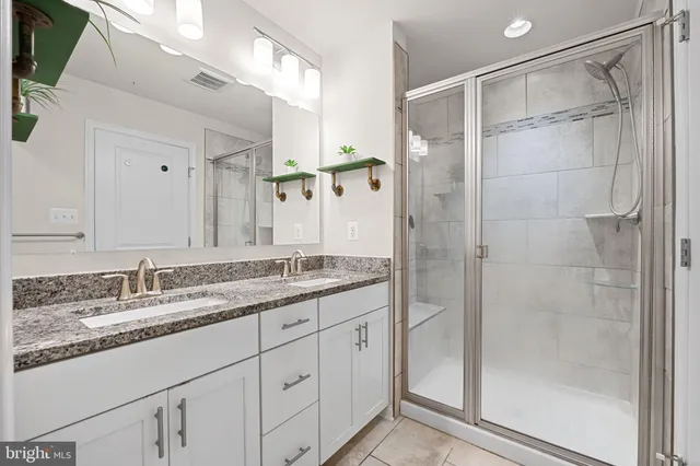 a bathroom with a granite countertop sink mirror and double