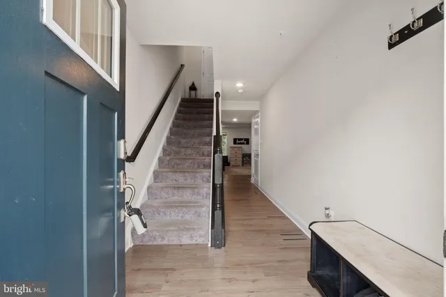 a view of entryway and hall with wooden floor
