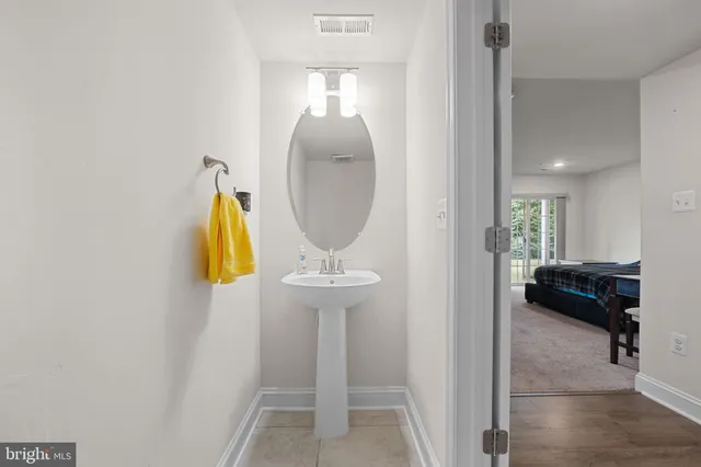 a living room with couches and painted walls with mirror